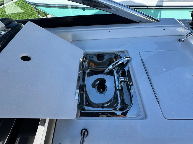 Slide: The Image of 2025 Monterey 255SS boat sink with chrome faucet and cover. - 9