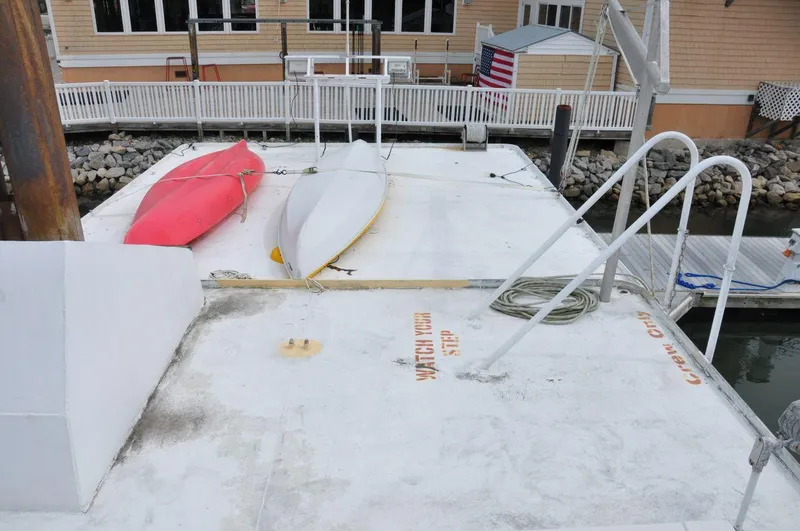 Slide: The Image of Rooftop view of 1999 Rodriquez 50 Pilothouse with kayaks and dockside background. - 12