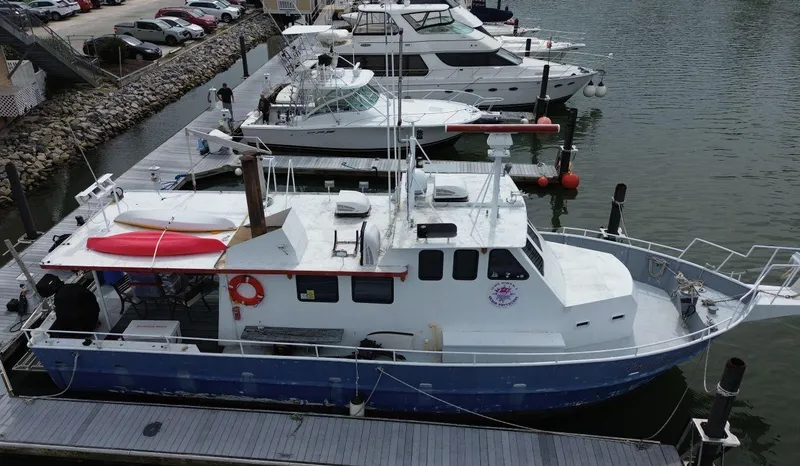Slide: The Image of 1999 Rodriquez 50 Pilothouse docked at marina with other boats. - 15