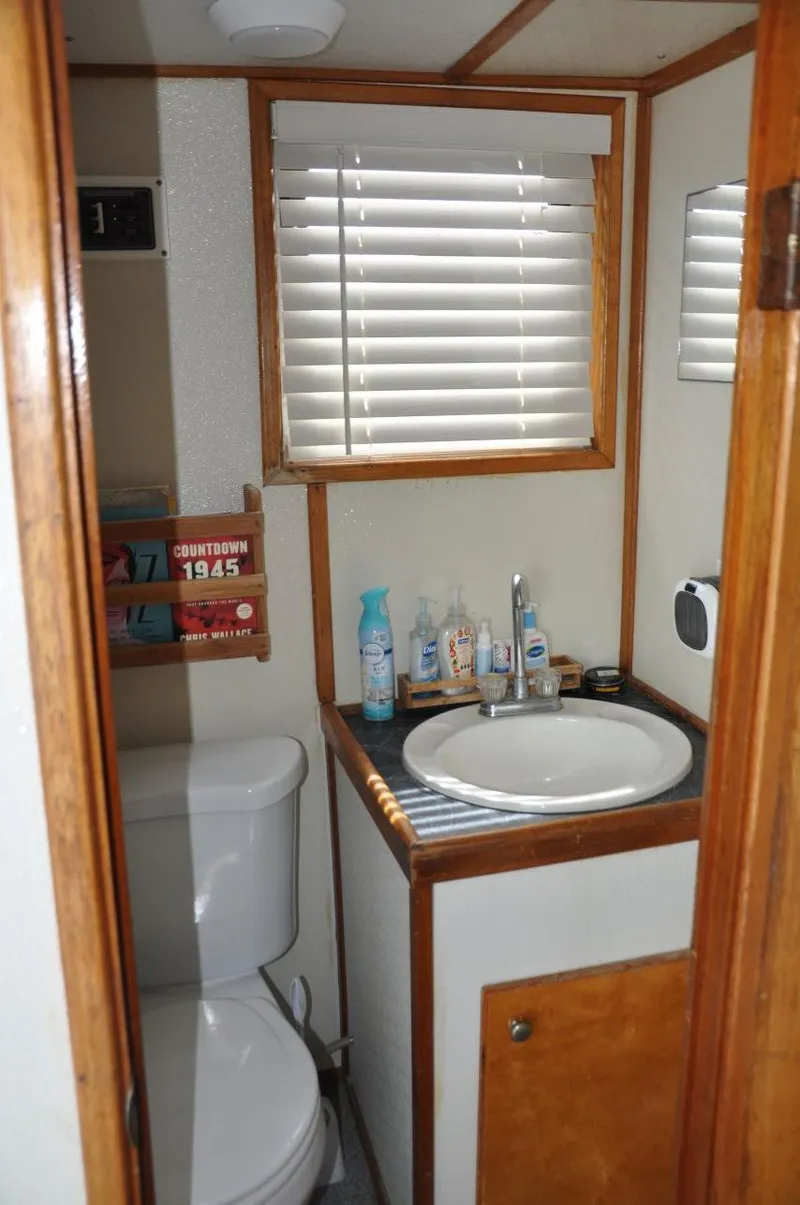 Slide: The Image of 1999 Rodriquez 50 Pilothouse bathroom with sink, toilet, and toiletries. - 19