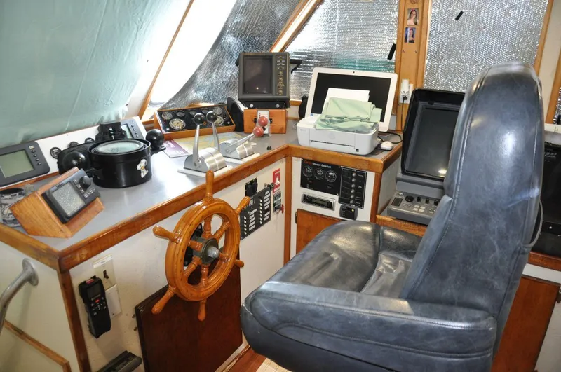 Slide: The Image of 1999 Rodriquez 50 Pilothouse interior with navigation equipment and captain's chair. - 22