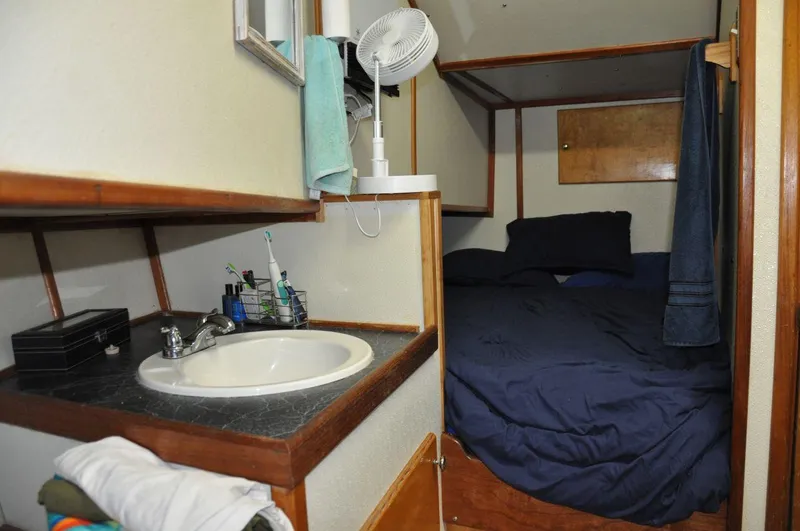 Slide: The Image of Cozy cabin interior of 1999 Rodriquez 50 Pilothouse with bed and sink area. - 28