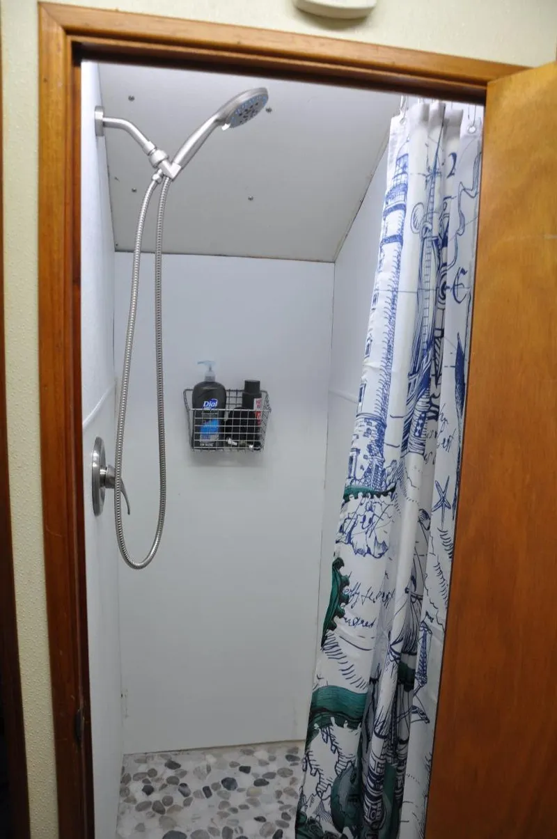 Slide: The Image of Shower area in 1999 Rodriquez 50 Pilothouse with nautical-themed curtain. - 29