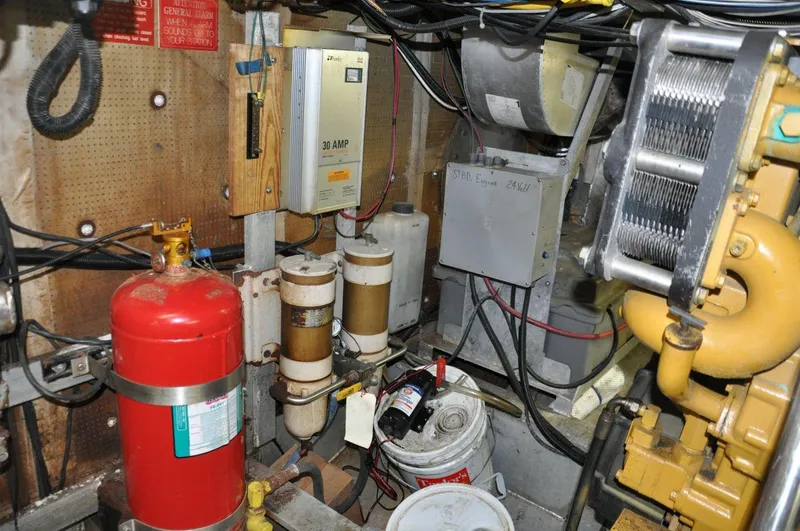 Slide: The Image of Engine room of 1999 Rodriquez 50 Pilothouse with equipment and fire extinguisher. - 33