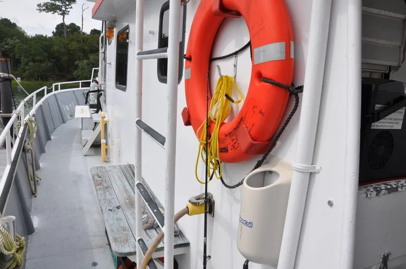 Slide: The Image of 1999 Rodriquez 50 Pilothouse deck with life preserver and safety equipment. - 7