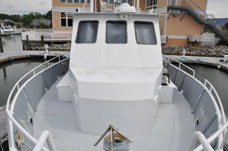 Slide: The Image of 1999 Rodriquez 50 Pilothouse boat docked at marina, front view. - 9