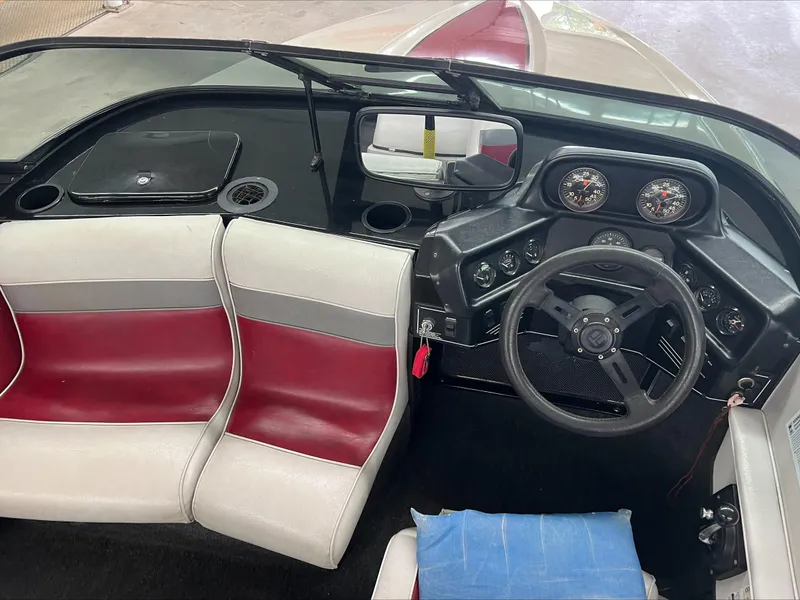 Slide: The Image of 1990 American Skier Legend boat interior with red and white seats, steering wheel, and dashboard controls. - 10