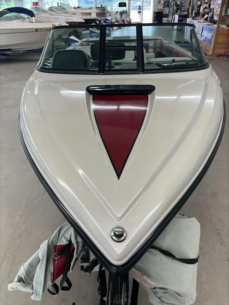 Slide: The Image of 1990 American Skier Legend boat, white with red detailing, displayed indoors. - 12