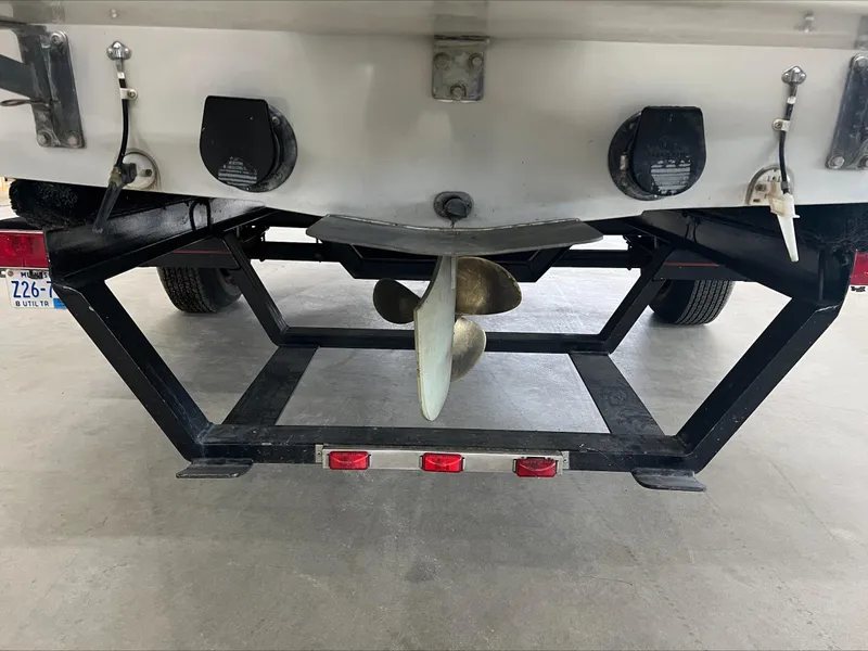 Slide: The Image of Rear view of 1990 American Skier Legend boat with propeller and trailer. - 13