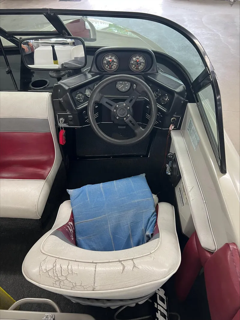 Slide: The Image of 1990 American Skier Legend boat interior with steering wheel and gauges. - 14