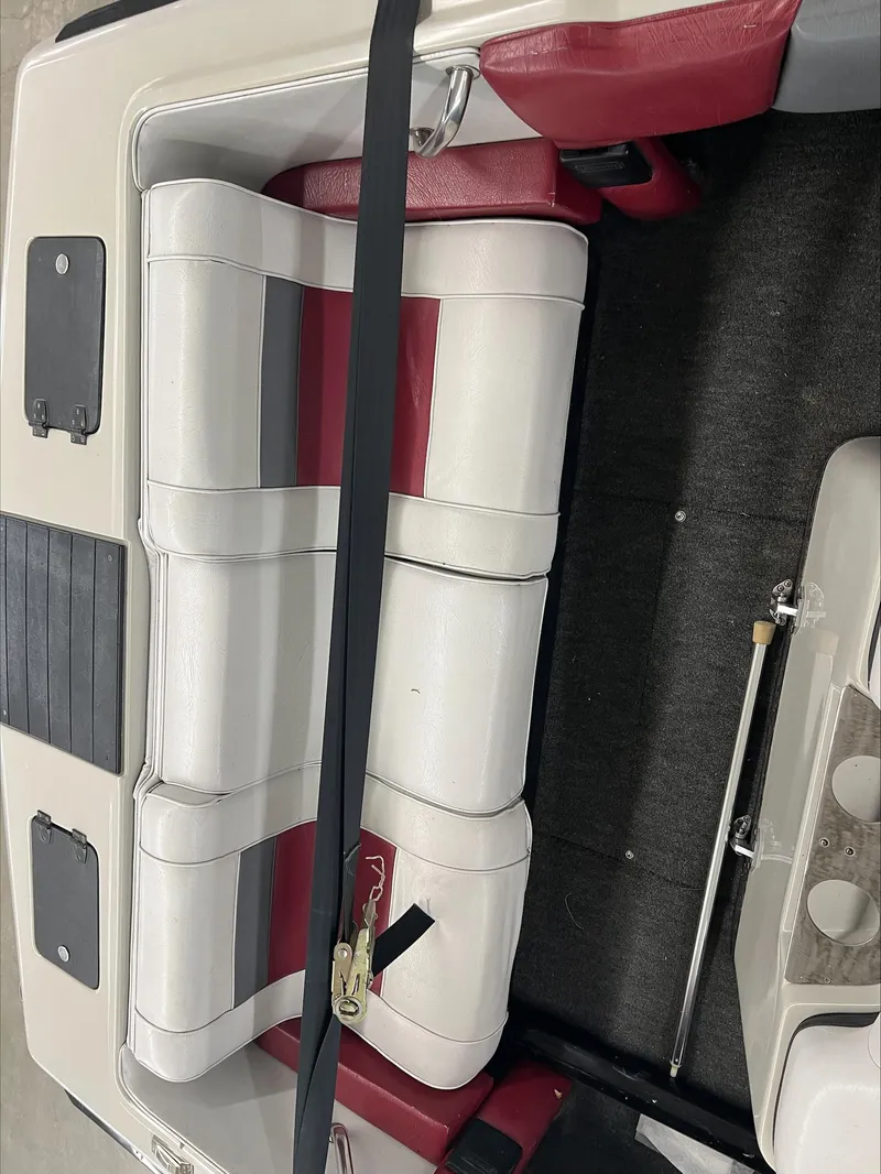 Slide: The Image of 1990 American Skier Legend boat interior with red and white seating. - 15