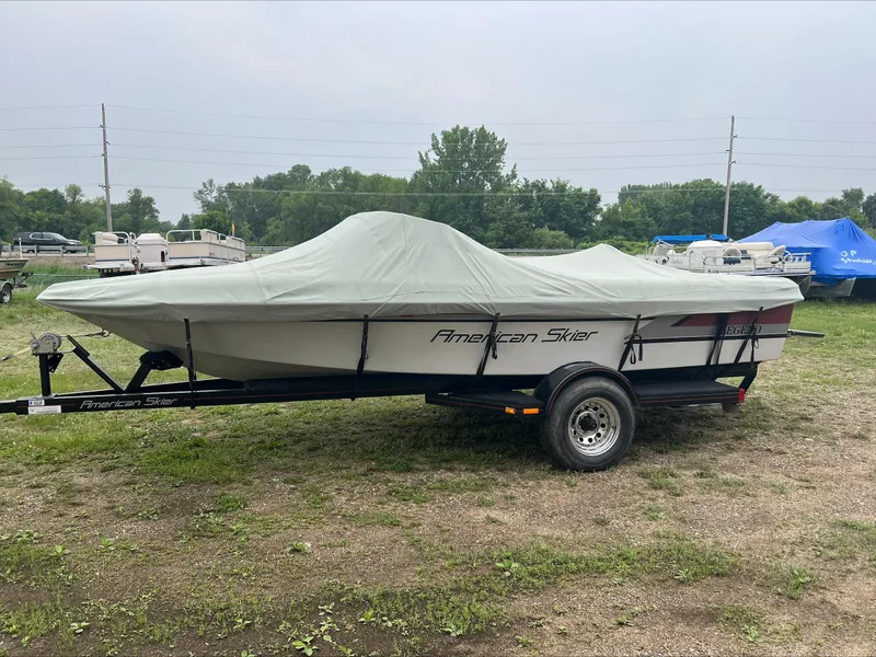 Slide: The Image of Covered 1990 American Skier Legend boat on trailer in outdoor setting. - 5