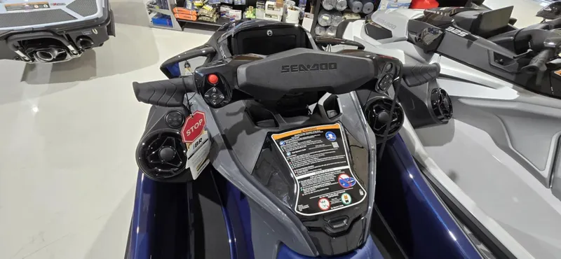 Slide: The Image of 2025 Sea-Doo GTX 230 jet ski dashboard with controls and display in showroom. - 3