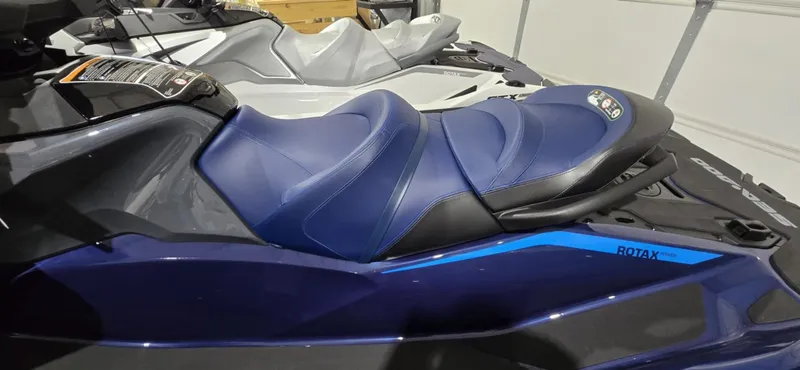 Slide: The Image of 2025 Sea-Doo GTX 230 jet ski with blue seat and sleek design in a garage setting. - 4