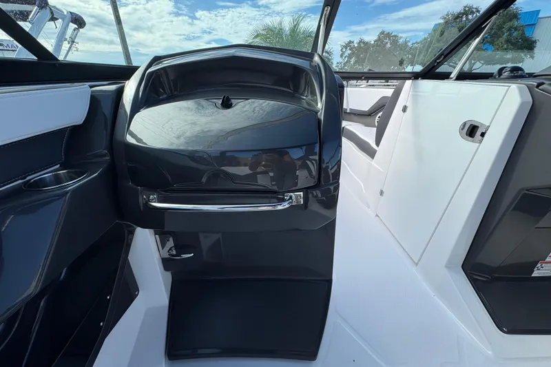 Slide: The Image of 2025 Monterey 255SS boat interior with sleek black and white design. - 11