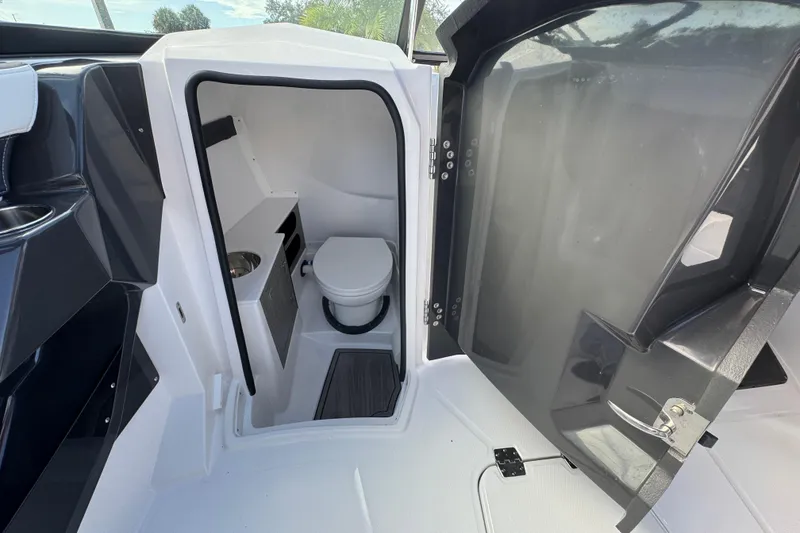 Slide: The Image of 2025 Monterey 255SS boat interior with compact bathroom and toilet. - 12