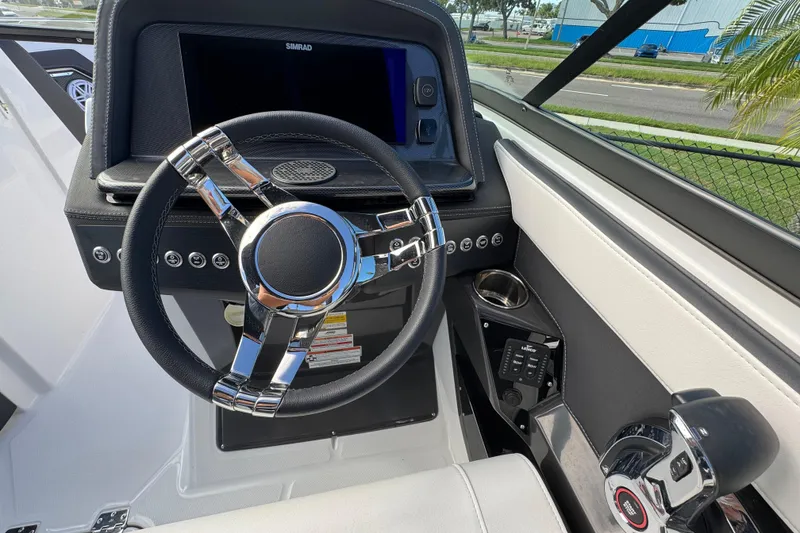 Slide: The Image of 2025 Monterey 255SS boat dashboard with steering wheel and control panel. - 14