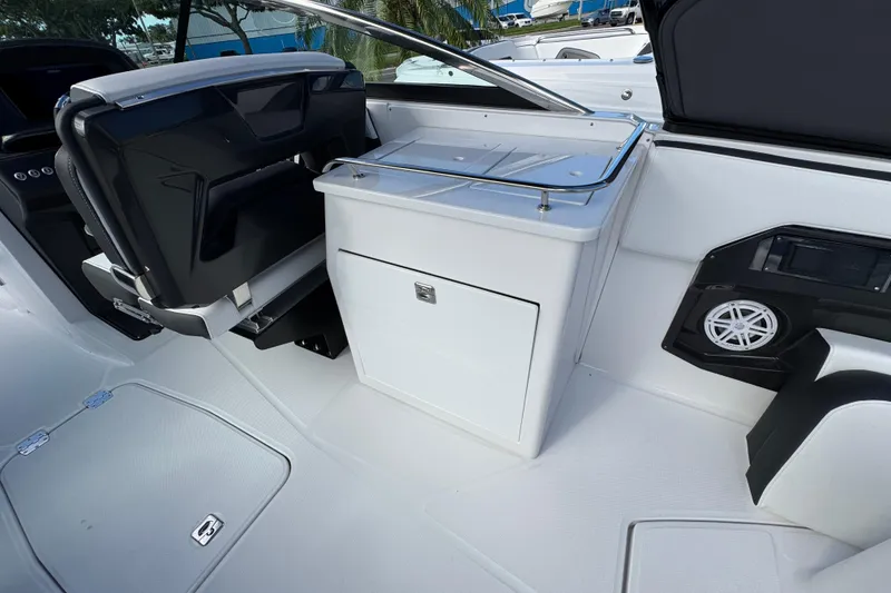 Slide: The Image of 2025 Monterey 255SS boat interior with seating, storage, and speaker system. - 5