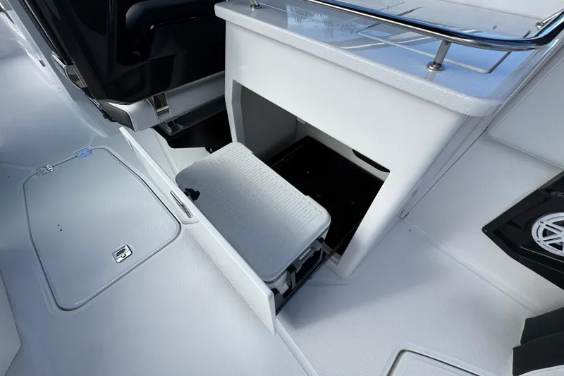 Slide: The Image of 2025 Monterey 255SS boat interior with storage compartment and cooler. - 6