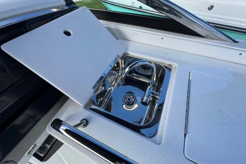 Slide: The Image of 2025 Monterey 255SS boat sink with chrome faucet and white countertop. - 7
