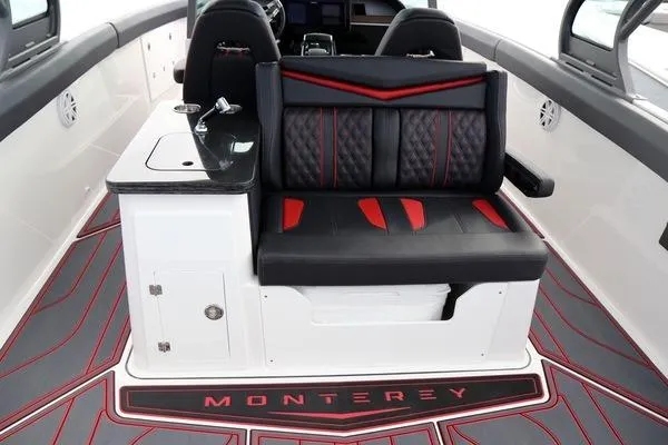Slide: The Image of 2026 Monterey Elite 30 OB boat interior with black and red seating and sleek design. - 8