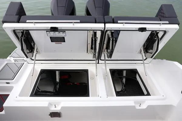Slide: The Image of 2026 Monterey Elite 30 OB boat storage compartments open on the deck. - 13
