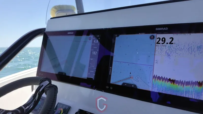 Slide: The Image of 2023 CG Boat Works 35 M-Series dashboard with Simrad navigation displays. - 13