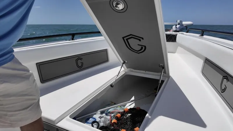 Slide: The Image of 2023 CG Boat Works 35 M-Series open storage compartment on deck, ocean in background. - 15