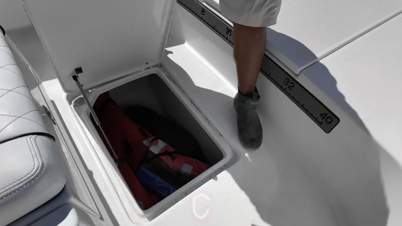 Slide: The Image of Open storage compartment on 2023 CG Boat Works 35 M-Series, featuring a measuring scale. - 16