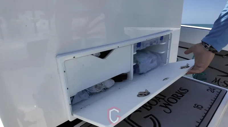 Slide: The Image of Storage compartment on 2023 CG Boat Works 35 M-Series, open with visible contents. - 26