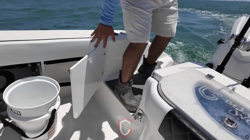 Slide: The Image of Person on 2023 CG Boat Works 35 M-Series, accessing storage compartment on deck. - 30