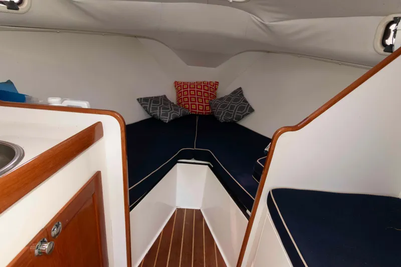 Slide: The Image of Cozy cabin interior of 2005 Holby Pilot 24 sailboat with cushions and wood accents. - 12