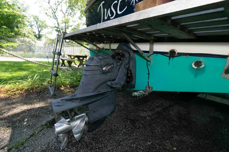 Slide: The Image of Rear view of a 2005 Holby Pilot 24 boat with visible propeller and ladder. - 18