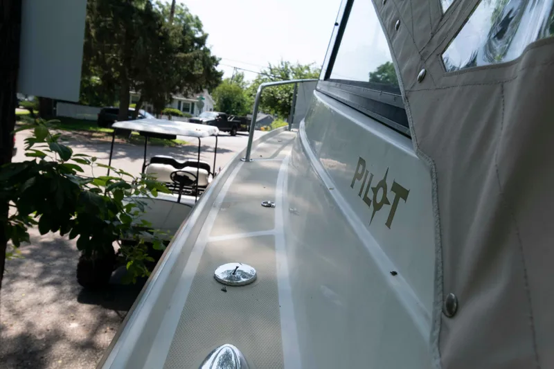 Slide: The Image of 2005 Holby Pilot 24 boat parked on a residential street. - 2