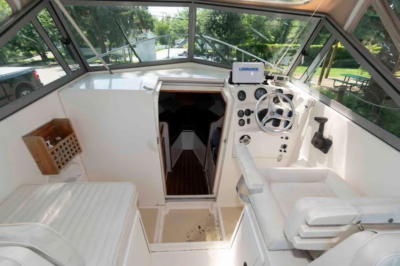 Slide: The Image of Interior of a 2005 Holby Pilot 24 boat with steering wheel and navigation equipment. - 5