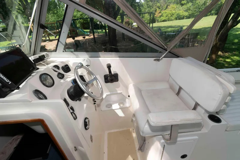 Slide: The Image of Interior of a 2005 Holby Pilot 24 boat with steering wheel and controls. - 6