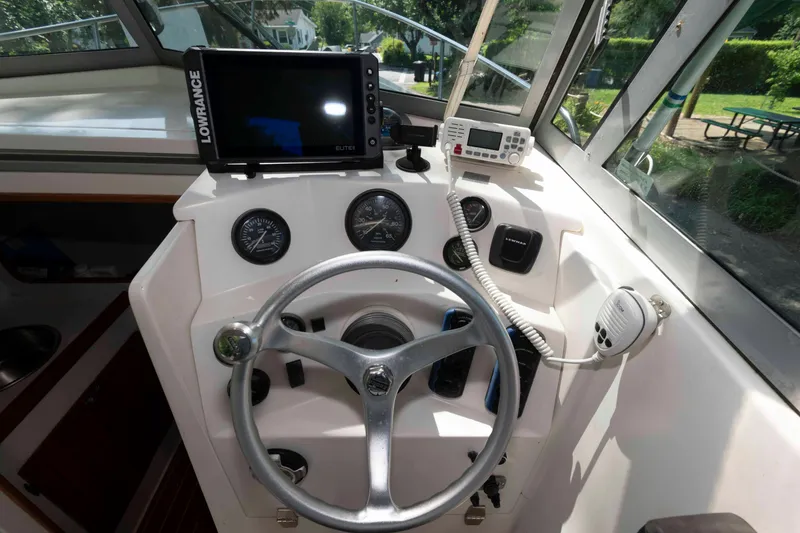 Slide: The Image of Holby Pilot 24 boat dashboard with steering wheel and navigation equipment, 2005 model. - 8