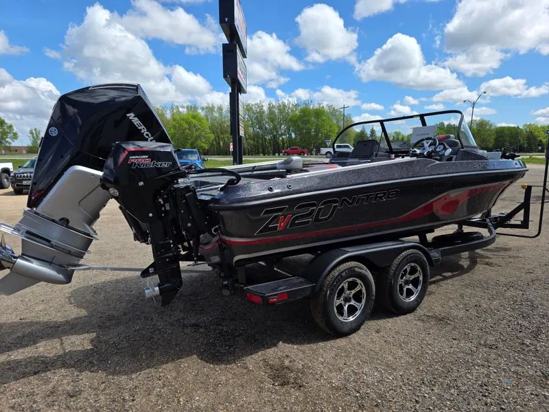 Slide: The Image of 2025 Nitro ZV-20 SPORT boat with powerful outboard motor, parked outdoors under a blue sky. - 1