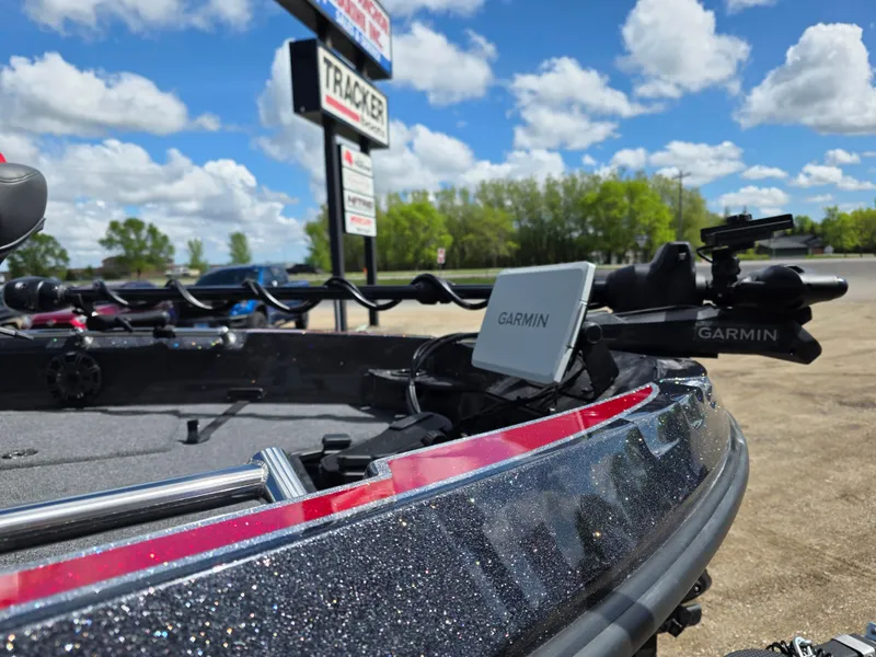Slide: The Image of 2025 Nitro ZV-20 SPORT boat with Garmin equipment, parked outdoors under a blue sky. - 5
