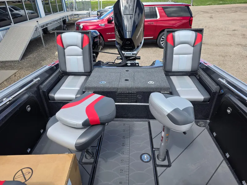 Slide: The Image of 2025 Nitro ZV-20 SPORT boat interior with red and gray seating, parked near a red SUV. - 6