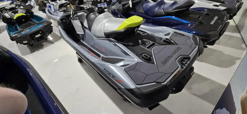 Slide: The Image of 2025 Sea-Doo RXT-X 325 jet ski in showroom, featuring sleek design and vibrant colors. - 2