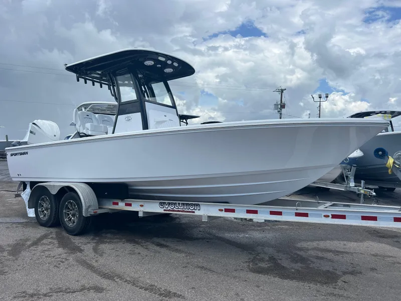 Slide: The Image of 2025 Sportsman Masters 247OE Bay Boat on trailer, under cloudy sky. - 1