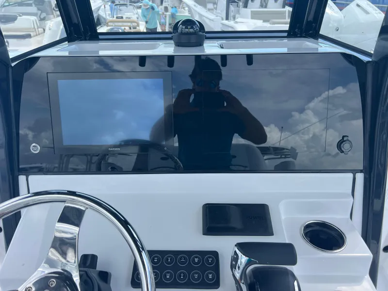 Slide: The Image of 2025 Sportsman Masters 247OE Bay Boat dashboard with steering wheel and touchscreen display. - 11