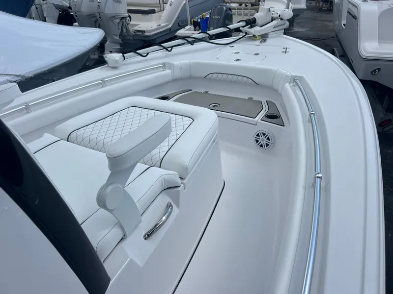 Slide: The Image of 2025 Sportsman Masters 247OE Bay Boat interior with white seating and sleek design. - 12