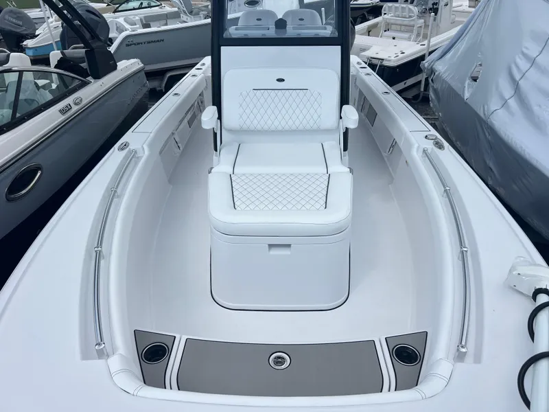 Slide: The Image of 2025 Sportsman Masters 247OE Bay Boat, sleek white deck with cushioned seating. - 13