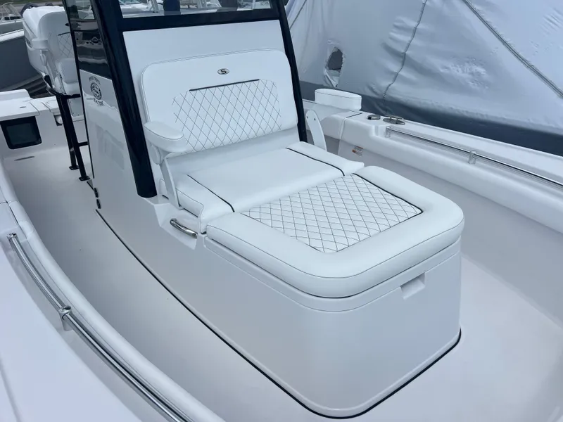 Slide: The Image of 2025 Sportsman Masters 247OE Bay Boat interior with white cushioned seating. - 15