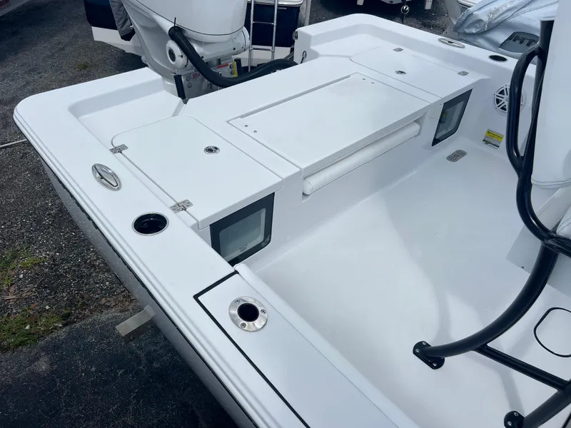 Slide: The Image of 2025 Sportsman Masters 247OE Bay Boat deck with storage compartments and rod holders. - 17
