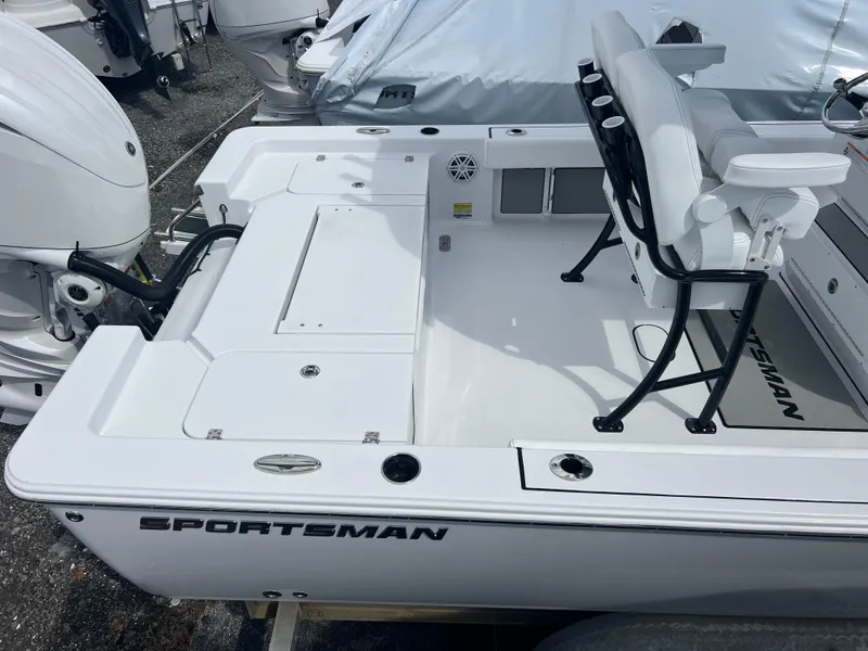 Slide: The Image of 2025 Sportsman Masters 247OE Bay Boat, white deck, seating, and outboard motor. - 18