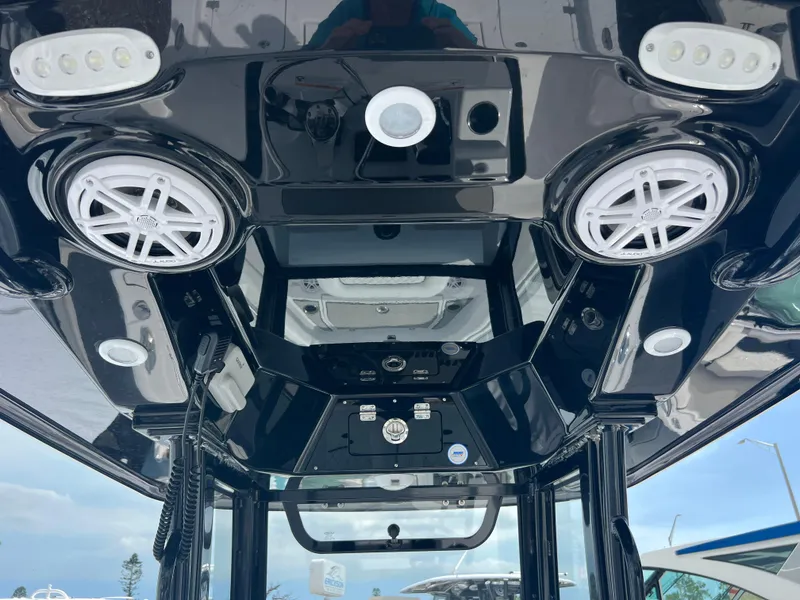 Slide: The Image of 2025 Sportsman Masters 247OE Bay Boat console with speakers and LED lights. - 23