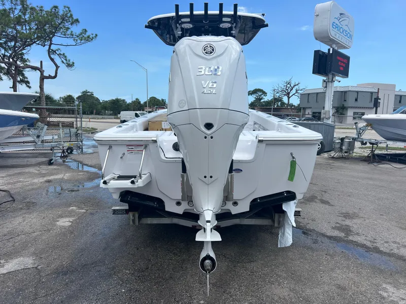 Slide: The Image of 2025 Sportsman Masters 247OE Bay Boat with Yamaha 300 V6 engine, parked outdoors. - 4